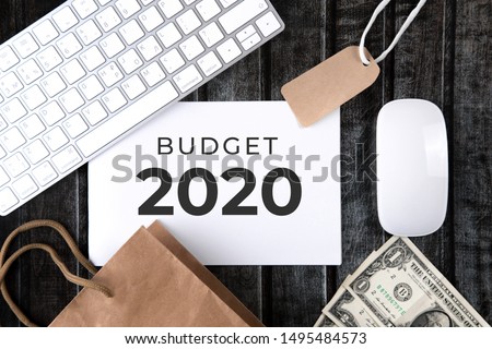Budget 2020 on the office desk in a notebook. Plans and goals for the new year. Top view layout on white background