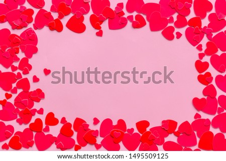Frame with hearts for present carts design on pink background top view copyspace