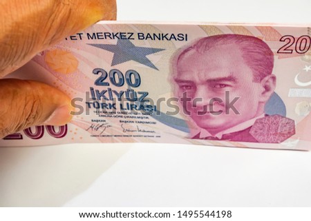 close up turkish lira banknotes with hand. 