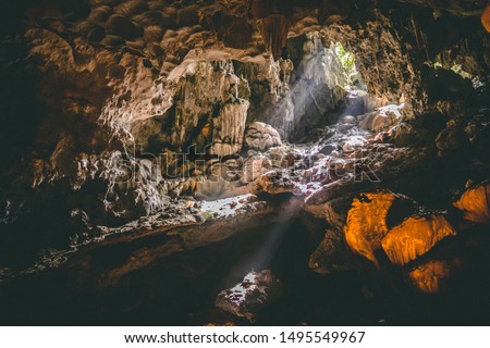 Tropical holiday destination. South East asian travel destination. Halong Bay caves, Vietnam. Sun beam through cave. Tropical tourist vacation. 