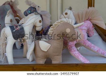 Stuffed colorful joy textile toys, horse, unicorn, animals for sale in toy store. Dolls as presents gifts for kids party birthday celebration