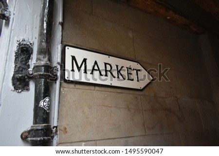 A market street sign next to an old lampost
