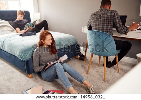 Group Of College Students In Shared House Bedroom Studying Together Royalty-Free Stock Photo #1495610321