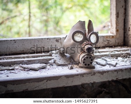 Old children's gas mask inside of the abandoned Pripyat Elementary School No. 3 in Pripyat city, Chernobyl Exclusion Zone, Ukraine Royalty-Free Stock Photo #1495627391