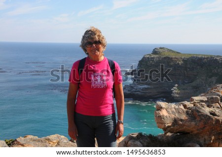 Tourist hiking at Cape Point, looking at view of Cape of Good Hope
