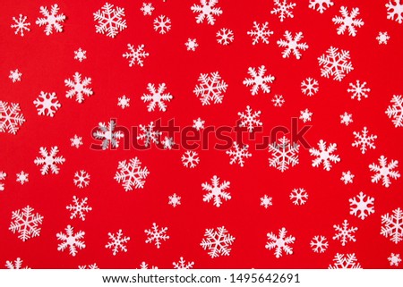 Creative arrangement of christmas decoration snowflakes on red background. Holiday concept. Flat lay, top view.