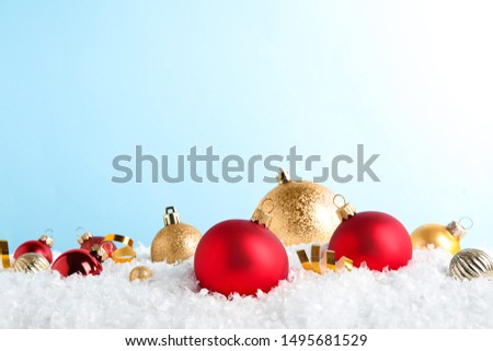 Christmas tree decoration on artificial snow against light blue background. Space for text