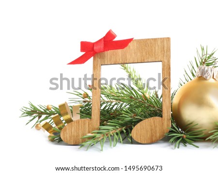 Music note with Christmas decorations isolated on white