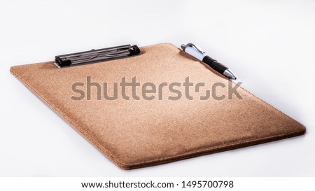 Cork spreadsheet and pen on white background

