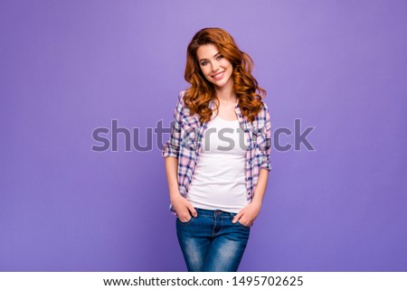 Photo of pretty ginger lady with amazing wavy hairstyle wear checkered casual shirt and blue jeans isolated purple color background