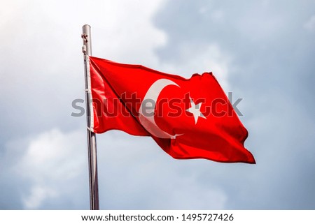 Turkish flag fluttering on a metal flagpole 