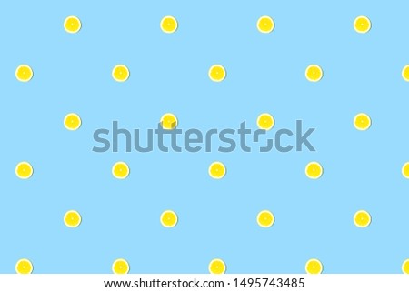 Seamless pattern of fresh lemon cut on blue