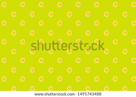 Seamless pattern of fresh lemon cut on green