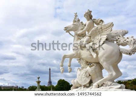 View from Tuileries Garden with Tour Eiffel and statue, copy of Mercure Riding Pegasus by Antoine Coysevox (1702). Paris, France.