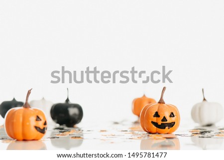 The halloween holiday concept with pumpkins on white table for background, design with copy space for text, advertising and banner.