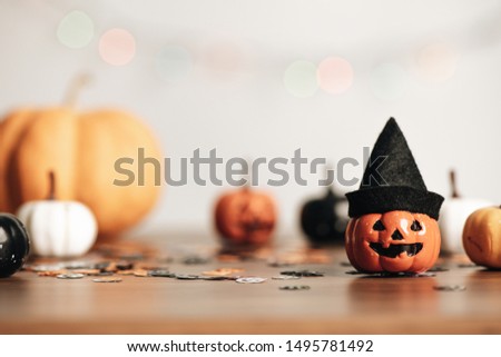 Happy halloween holiday concept with pumpkins on wooden table for background, design with copy space for text, advertising and banner.