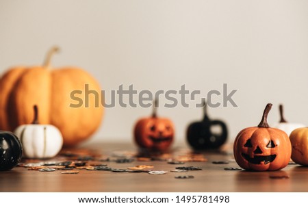 Happy halloween concept with pumpkin Jack O'Lantern on wooden table for background, design with copy space for text, advertising and banner.