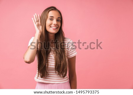 Image of a positive cheery young pleased girl posing isolated over pink wall background try to hear you.