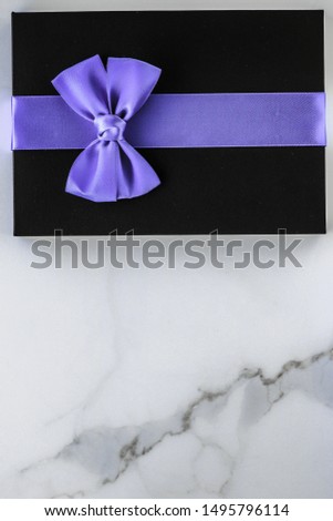 Wedding present, shop sale promotion and anniversary celebration concept - Luxury holiday gifts with lavender silk ribbon and bow on marble background