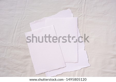 Minimalistic card mockup on textile background. Flat lay, top view.  Wedding invitation card