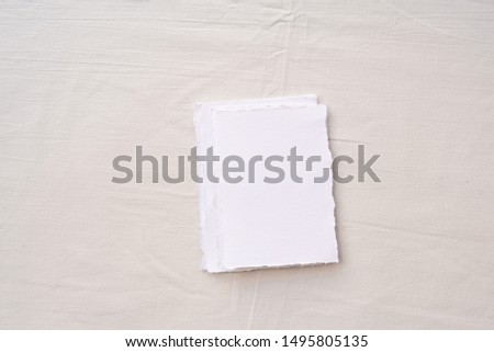 Minimalistic card mockup on textile background. Flat lay, top view.  Wedding invitation card