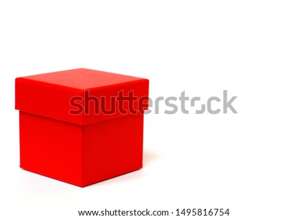 Red gift box with a lid on a white background. There is a place for text. Bright red box without inscriptions.