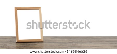 wooden frame on wooden table on white background 