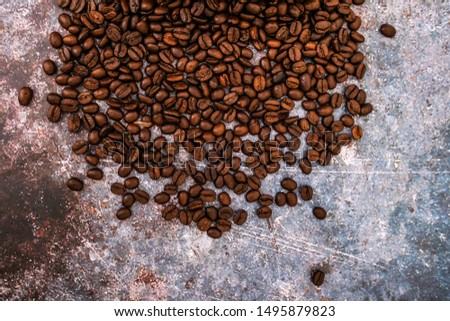 Roasted brown coffee beans on the rustic table. Top view Photo.