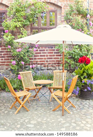 Image of romantic garden seating area outside period style home or pub/cafe.