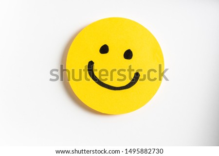 Drawing of a happy smiling emoticon on a yellow paper and white background. Royalty-Free Stock Photo #1495882730