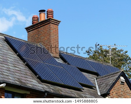 Residential solar panels on rooftop used to generate electricity Royalty-Free Stock Photo #1495888805