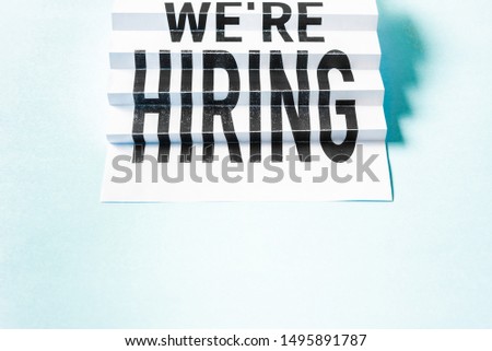 "We're hiring" zig-zag poster sign with empty space for text on blue background. Job board design banner, template. Concept of recruitment and job search.