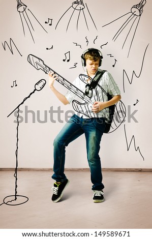 teenager is playing on drawn guitar at concert
