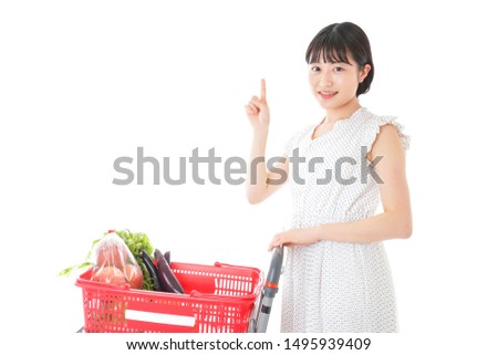 Young woman pointing at something at supermarket