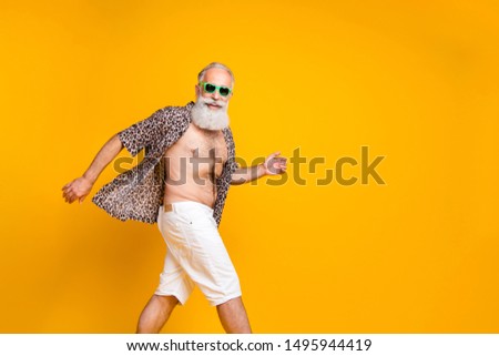 Photo of carefree old man having free time during his trip abroad while isolated with yellow background