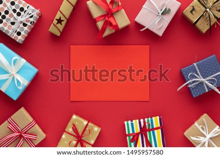 Christmas composition. Colorful gift boxes top view red background with copy space for your text. Flat lay.