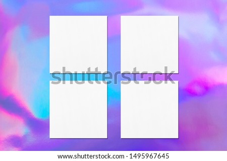 Four empty white square flyer or business card mockups with soft shadows on holographic background. Flat lay, top view
