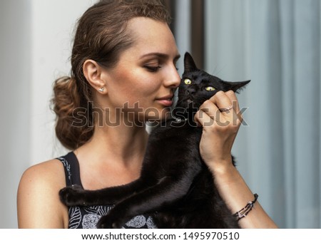 portrait of a beautiful girl with a cat hugs
