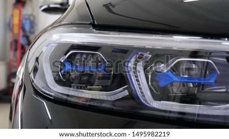 After professional polishing, ceramics and car washes show headlights on new cars. Concept of: Auto Service, Different Colors, Car wash, Presentation, Glittering Headlights.	
