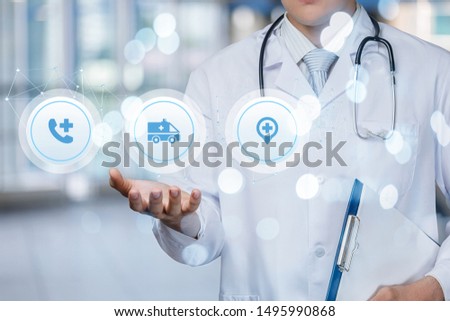 Doctor shows icons ambulance on blurred background.