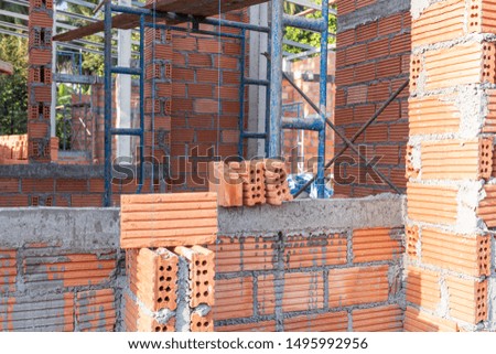 Check the level before lining up the bricks at new building residential  house construction 