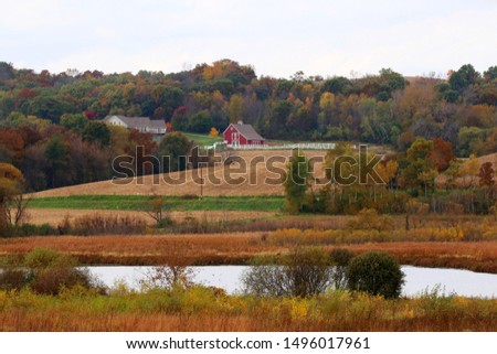 Beautiful autumn rural landscape. Scenic countryside fall view with colorful trees, agricultural fields and scattered farm buildings. Midwest USA, Wisconsin. Royalty-Free Stock Photo #1496017961