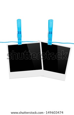 Black, blank photo frames on rope with blue, plastic clothespin, isolated on white background.