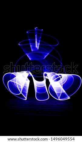 Curved abstract shape made with a light saber blue. Lightpainting session at night. Leds light effect. 