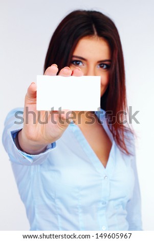 Businesswoman holding a blank card with a smile