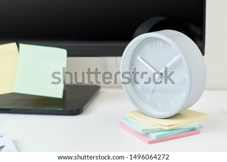 Modern workspace background. Workplace with clock, office supplies and sticky notes