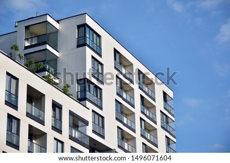 Modern and new apartment building. Multistoried modern, new and stylish living block of flats. Royalty-Free Stock Photo #1496071604