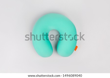 Travel blue sleeping pillow or Neck Pillow on grey background. Royalty-Free Stock Photo #1496089040
