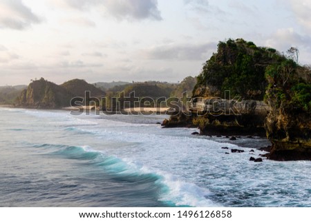 A beautiful picture of ocean and rock and blue wave taken at batu bengkung beach that located at malang,indonesia