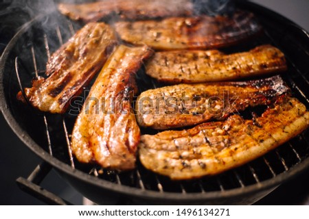 grilled steak. the meat is grilled. juicy pieces of meat in the smoke